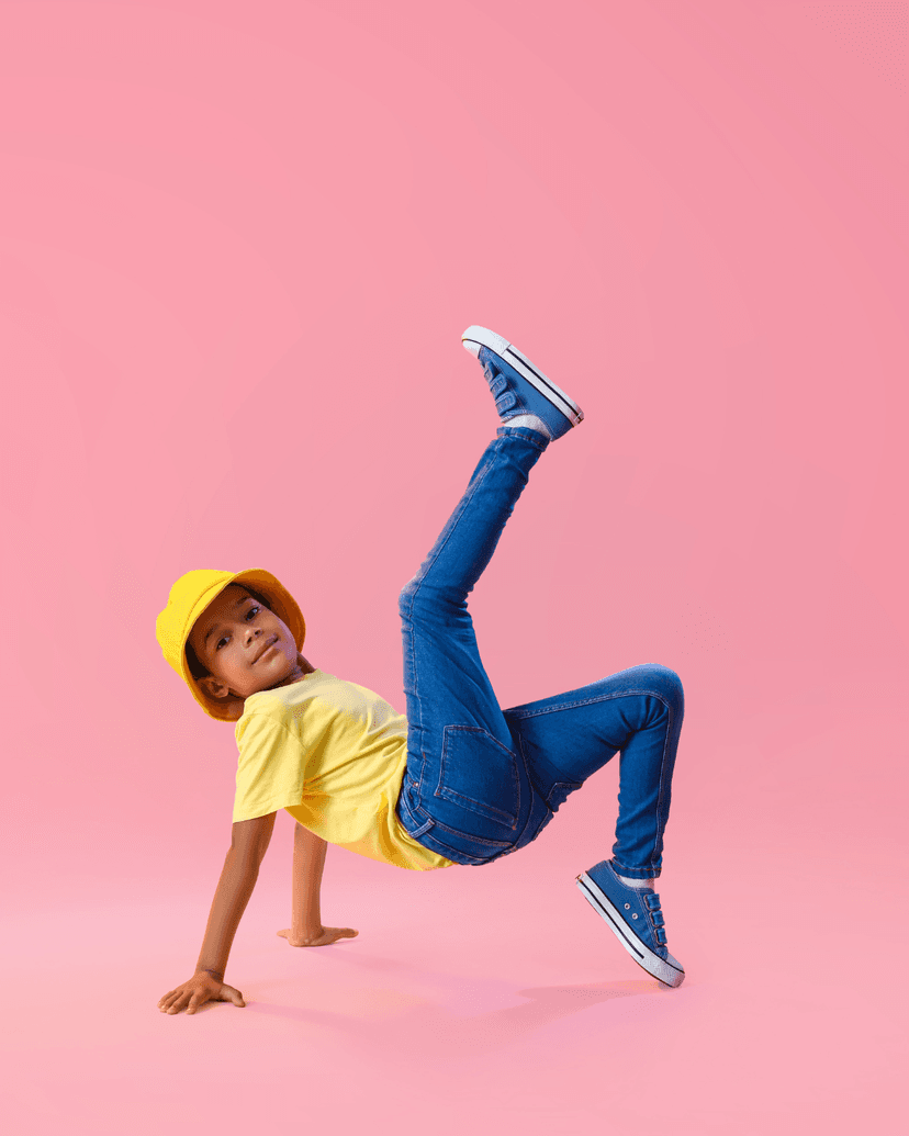 A happy child in a yellow hard hat